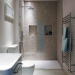 Narrow shower room with mosaic tiled wall