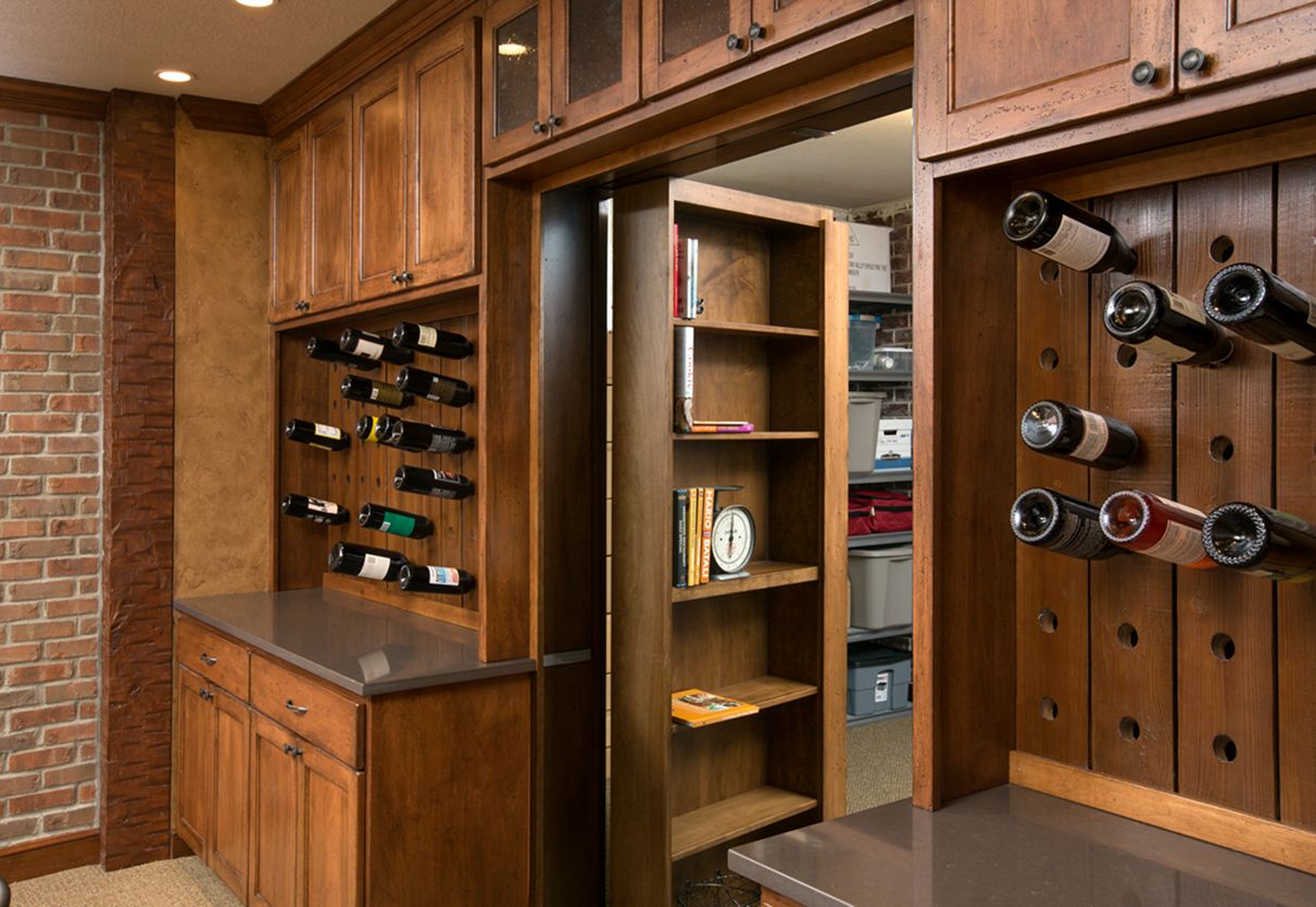door hidden in the wine rack bookcase via Cleary Company