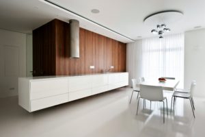 All-white kitchen interior with single wood