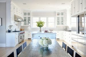 Tamara Magel kitchen with white cabinets and raw edge dining table.